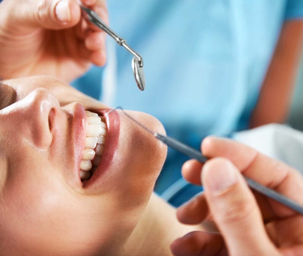 patient smiling with dental tools near smile