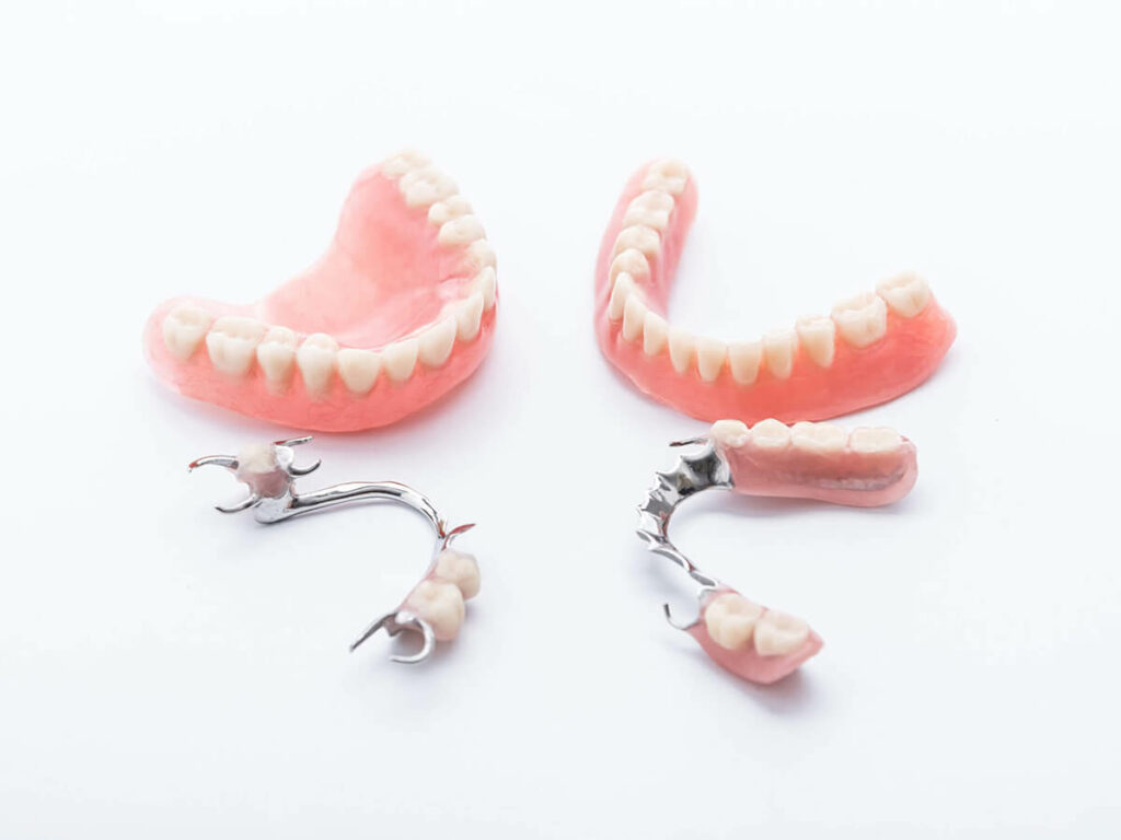different types of dentures on white surface